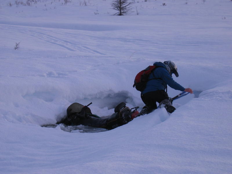 Ski-Doo sitting in a water hole.